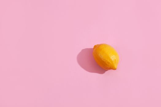 Trendy yellow lemon isometric pattern on pink background. Creative and modern minimal concept. Summer fresh flat lay food texture, copy space.
