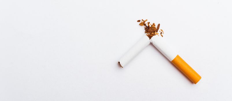 31 May of World No Tobacco Day, no smoking, close up of broken pile cigarette or tobacco STOP symbolic on white background with banner copy space, and Warning lung health concept