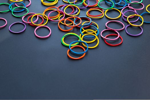 Teamwork concept. group of colorful rubber band on black background with copy space