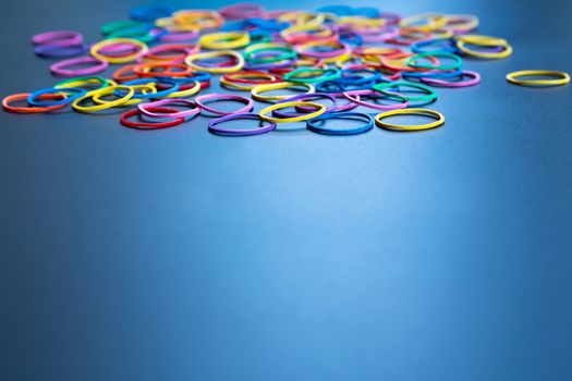 Diversity concept. mix colorful rubber band on black background with tcopy space