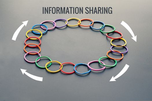Information sharing concept, colorful rubber band with word Information Sharing, flow arrow on black background