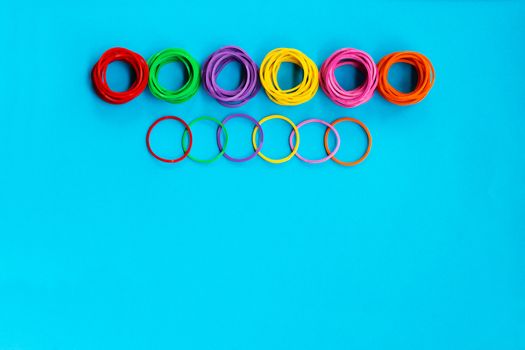 Teamwork concept. group of colorful rubber band on blue background with copy space