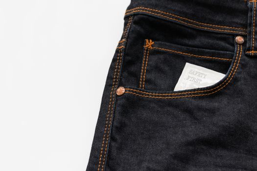 Condom in the jeans pocket with word safety first