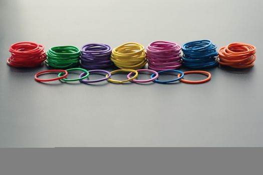 Diversity concept. mix colorful rubber band on black background with tcopy space