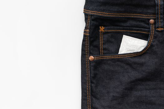 Condom in the jeans pocket with word safety first
