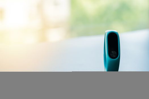 fitness smart band device blue color on black background, blank display with copy space