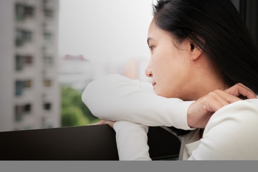depressed women sitting near window, alone, sadness, emotional concept