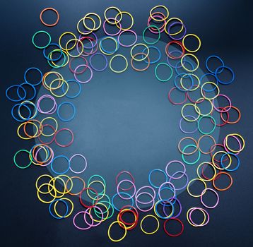 Diversity concept. mix colorful rubber band on black background with tcopy space