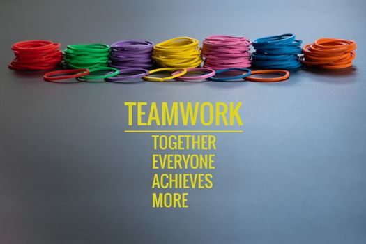 Teamwork concept. group of colorful rubber band on black background with word Teamwork, Together, Everyone, Achieves and More
