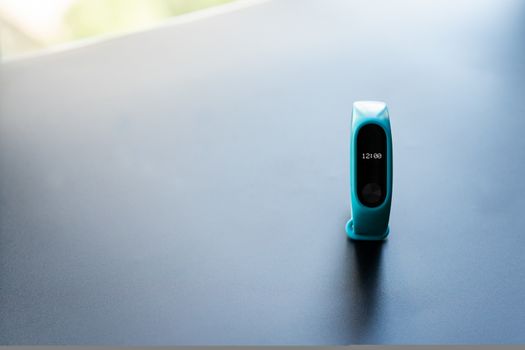 fitness clock smart band device blue color on black background