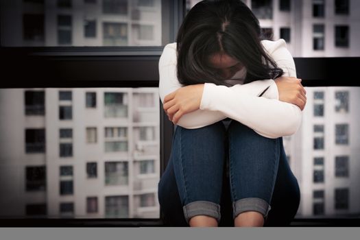 depressed women sitting near window, alone, sadness, emotional concept