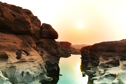 Sunrise new day at Sam Phan Bok, as known as the Grand Canyon of Thailand, the biggest rock reef in the Mae Khong River, in Ubon Ratchathani province, Thailand