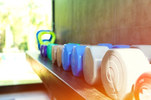 colorful dumbbell row in fitness gym for musclebuilding