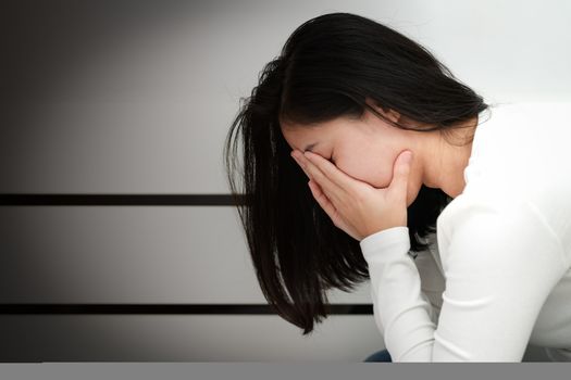 depressed women sitting in the corner of the room, alone, sadness, emotional concept