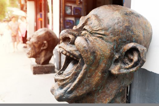 SHANGHAI, CHINA - JUNE 2018: Head of laughter bronze statues, funny head sculpture