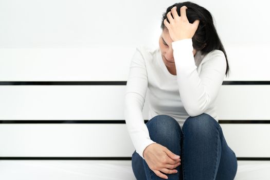 depressed women sitting in the room, alone, sadness, emotional concept