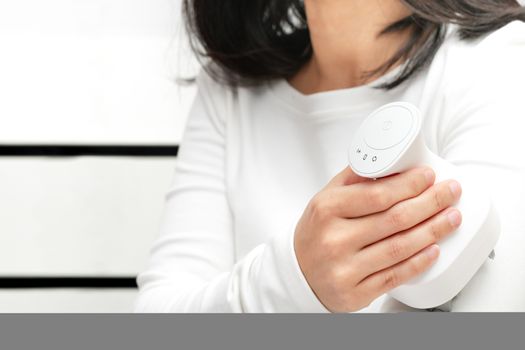 electric arm, neck and shoulder massage machine on women shoulder, closeup, healthcare and medicine concept
