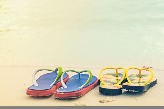2 slippers on the white sand beach, travel and vacation time