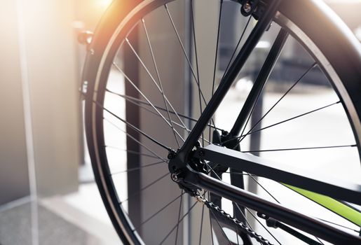 black wheel bicycle closeup on vintage scene