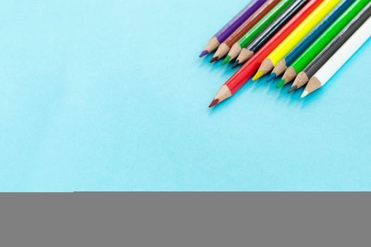 Education or back to school Concept. Close up shot of color pencil pile pencil nibs on blue background with copy space