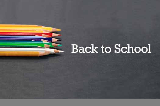 back to school Concept. Close up shot of color pencil pile pencil nibs on black background