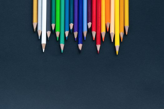back to school Concept. Close up shot of color pencil pile pencil nibs on black background with copy space