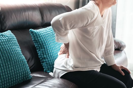 Old woman back pain at home, health problem concept
