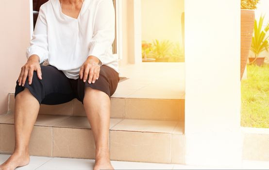 senior woman suffering from knee pain at home, health problem concept