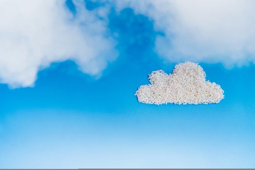 White rice as fluffy cloud shape in the deep blue sky background, cloud storage concept