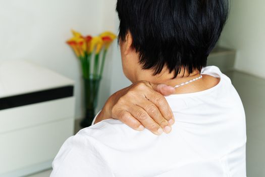 neck and shoulder pain, old woman suffering from neck and shoulder injury, health problem concept