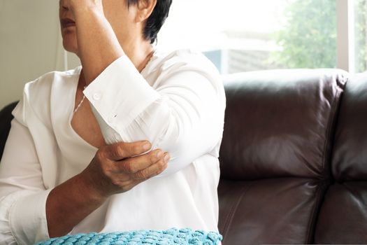 elbow pain/injury, old woman suffering from elbow pain, health problem concept