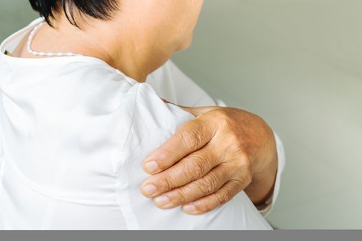 neck and shoulder pain, old woman suffering from neck and shoulder injury, health problem concept