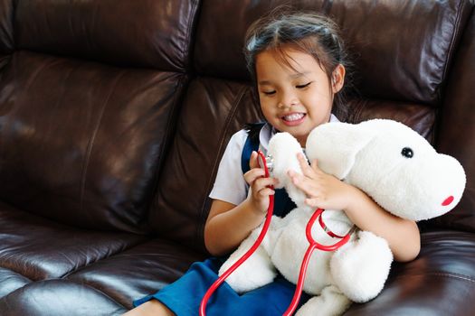 little girl are smiling and playing doctor with stethoscope. Kid and health care concept.