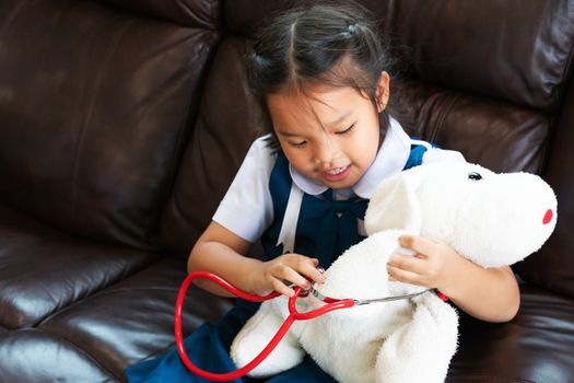 little girl are smiling and playing doctor with stethoscope. Kid and health care concept.