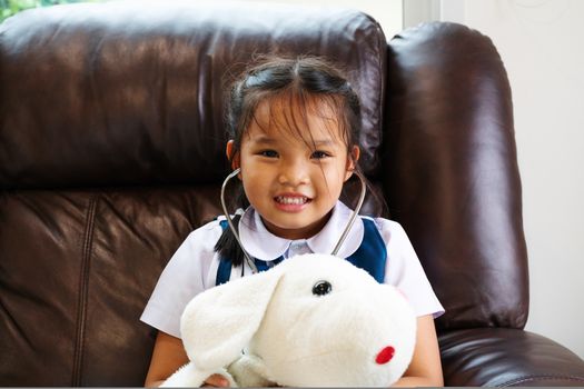 little girl are smiling and playing doctor with stethoscope. Kid and health care concept.