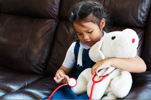 little girl are smiling and playing doctor with stethoscope. Kid and health care concept.