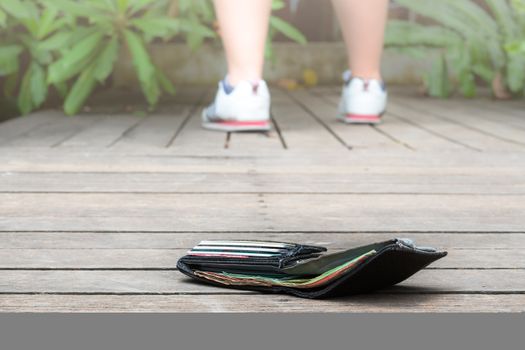 lost wallet with money and card on the walkway. Close-up wallet lying on sidewalk in during the trip