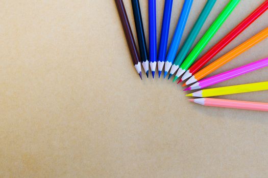 variety different color pencils on yellow background