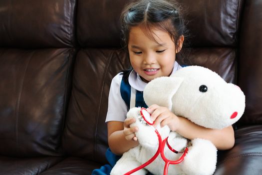 little girl are smiling and playing doctor with stethoscope. Kid and health care concept.