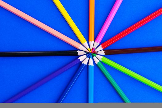 variety different color pencils on blue background