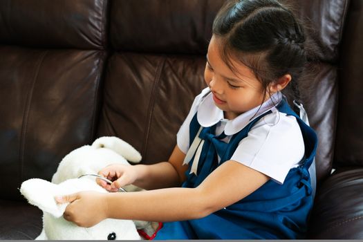 little girl are smiling and playing doctor with stethoscope. Kid and health care concept.
