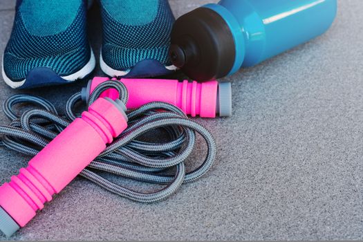 Jump rope, Running shoes, and drink bottle on the ground