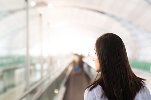 traveler with travel bag or luggage walking in the airport terminal walkway for air traveling. blur motion