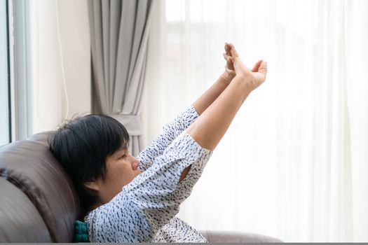 senior woman stress free on sofa at home