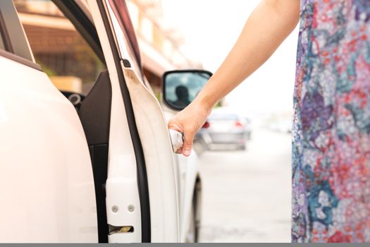 woman driver hand open the car door
