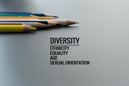 Diversity concept. row of mix color pencil on black background with text Diversity, Ethnicity, Equality, Age, Sexual Orientation