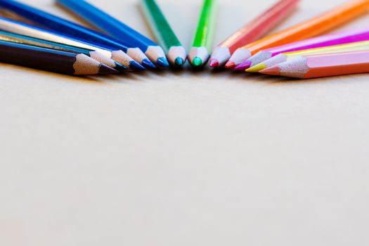 Teamwork concept. group of color pencil on brown background