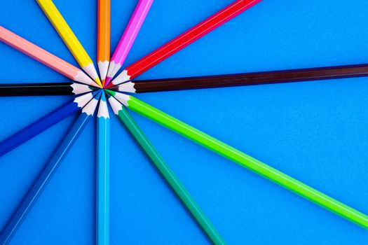 Teamwork concept. group of color pencil on blue background