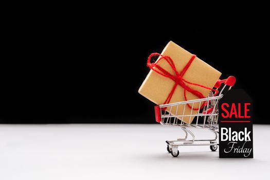 Black Friday sale, shopping cart and gift box with price tag
