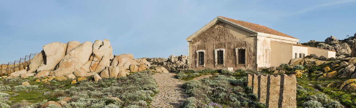 old abandonned house at capo testa teresa di gallura , with rocks and blue sea on the italian island of sardinia